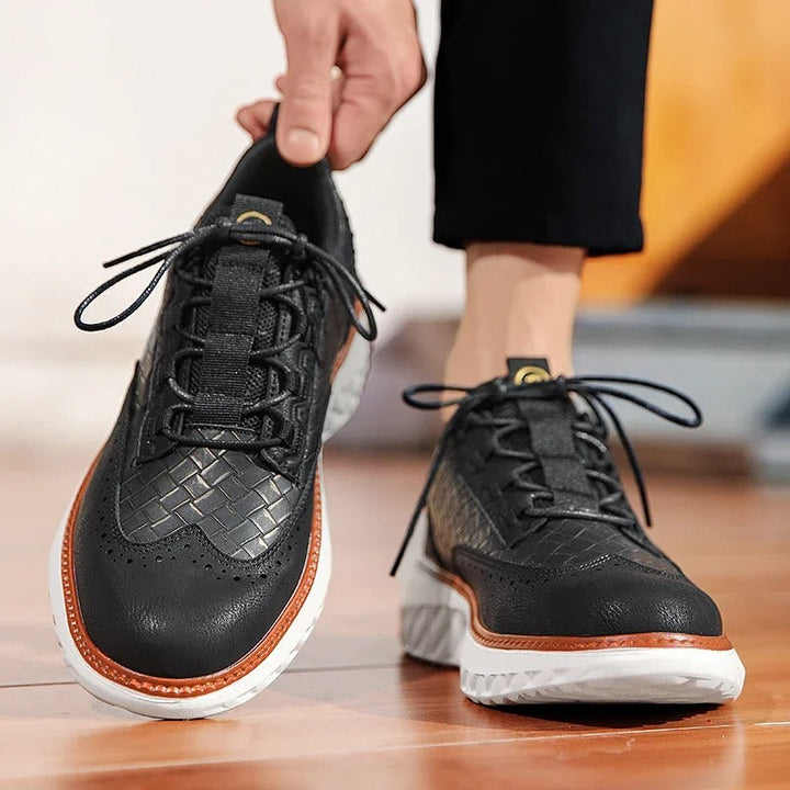 Close-up of a black everyday comfort athletic sneaker, showing breathable mesh upper.