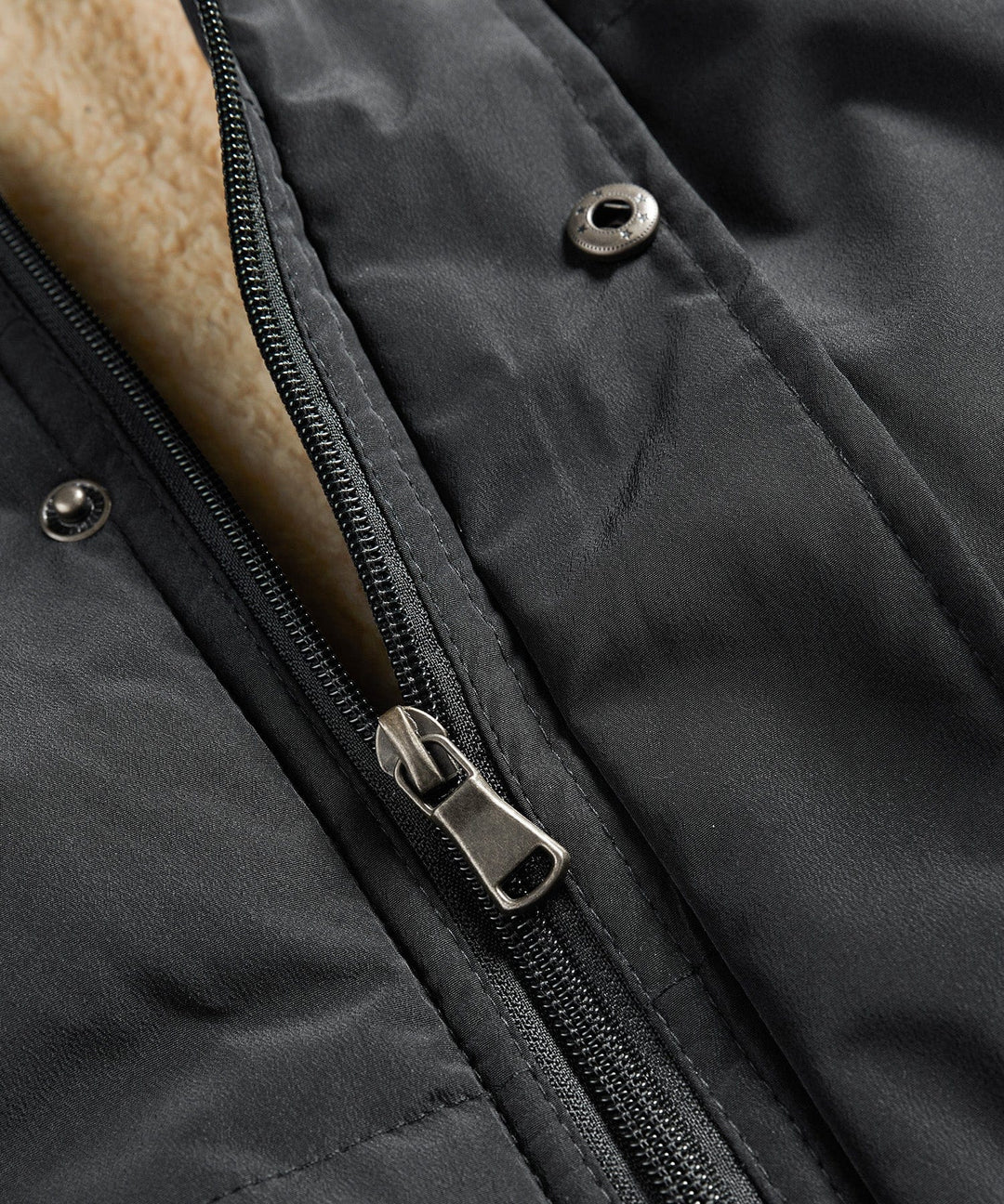 Flat lay of a folded insulated hooded puffer vest, ready for travel or storage