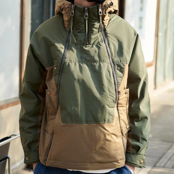 Side view of a black techwear jacket, highlighting the utility features and insulation