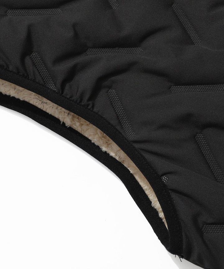 Detail shot of the zipper closure on a unisex quilted puffer vest, emphasizing quality and function