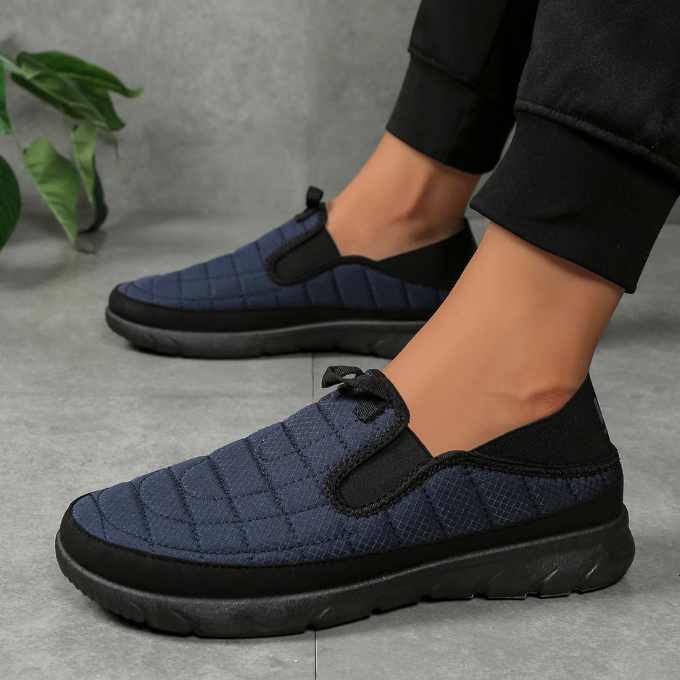 Top view of a single black slip-on comfort shoe, showcasing its breathable upper and slip-on design