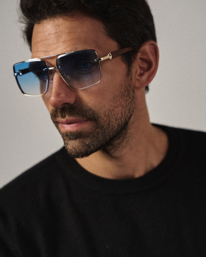 Side view of vintage-inspired square sunglasses, showcasing the unique gold-wood temple design.