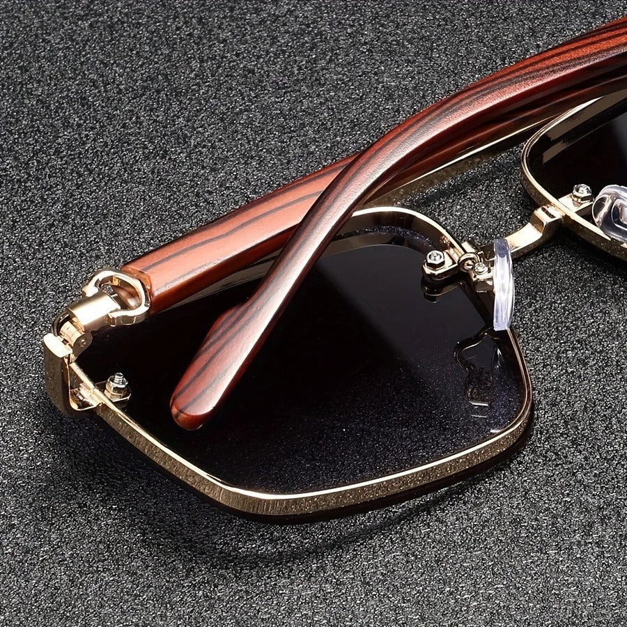 Detail of the hinge of bold square unisex sunglasses, showing the gold and wood craftsmanship.