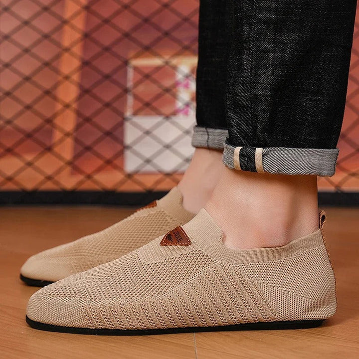 Angled view of a pair of knit comfort slip-ons, suitable for active or casual use.