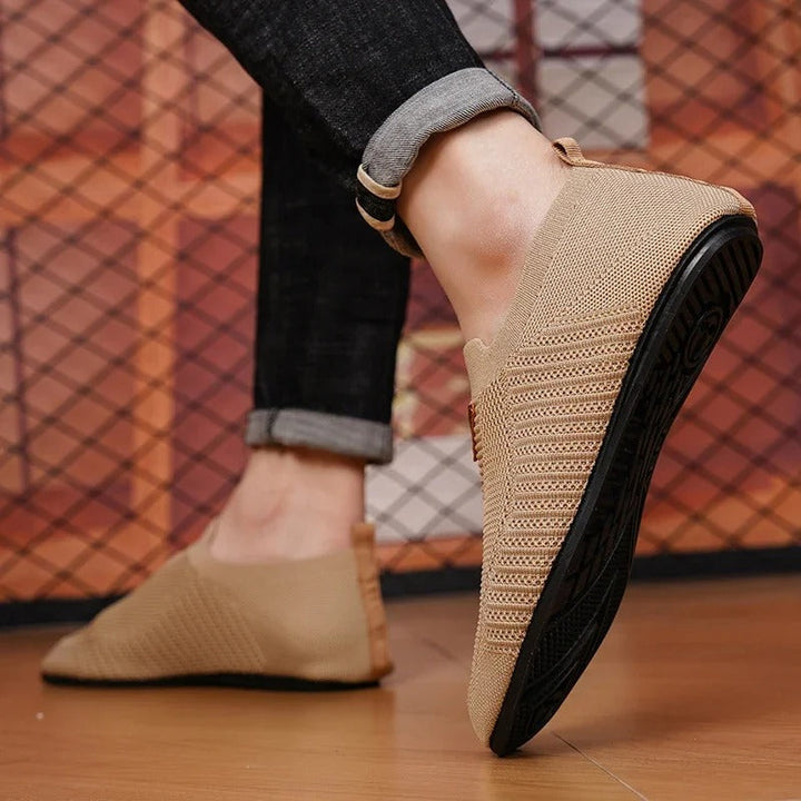 Breathable knit fabric detailing on a comfortable unisex slip-on walking shoe.