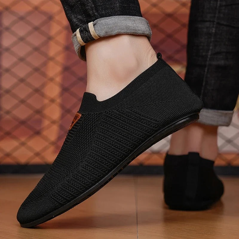 Pair of unisex slip-on knit shoes, showcasing breathable stretch fabric and comfort design.
