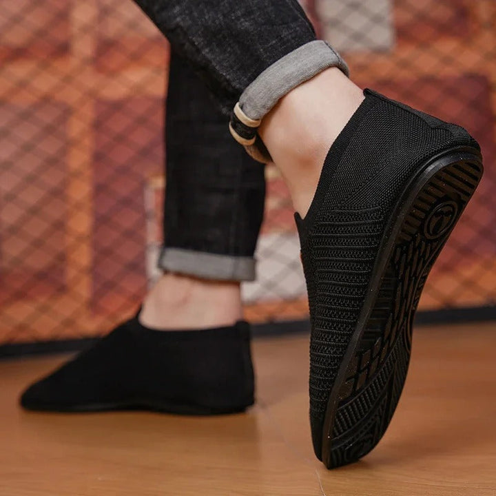 Close-up of the breathable knit texture on a unisex comfort slip-on shoe.