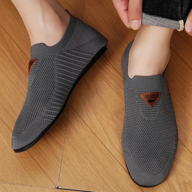Model wearing Unisex Breathable Knit Comfort Slip-On Shoes, demonstrating casual style.
