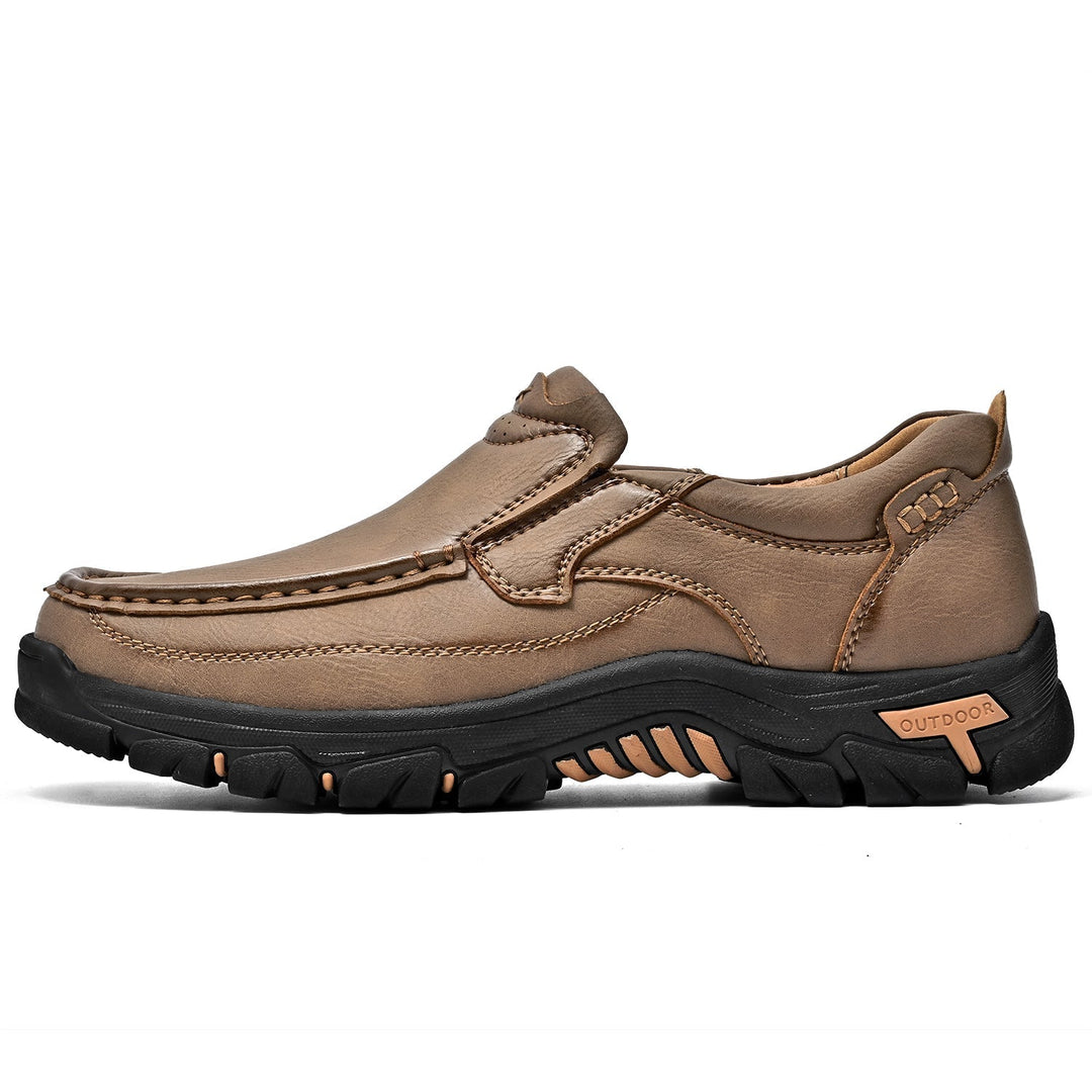 Detail of the resilient outsole of a brown orthopedic comfort transition boot, long-lasting