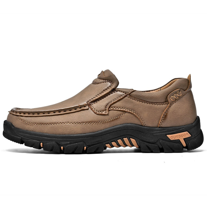 Detail of the resilient outsole of a brown orthopedic comfort transition boot, long-lasting