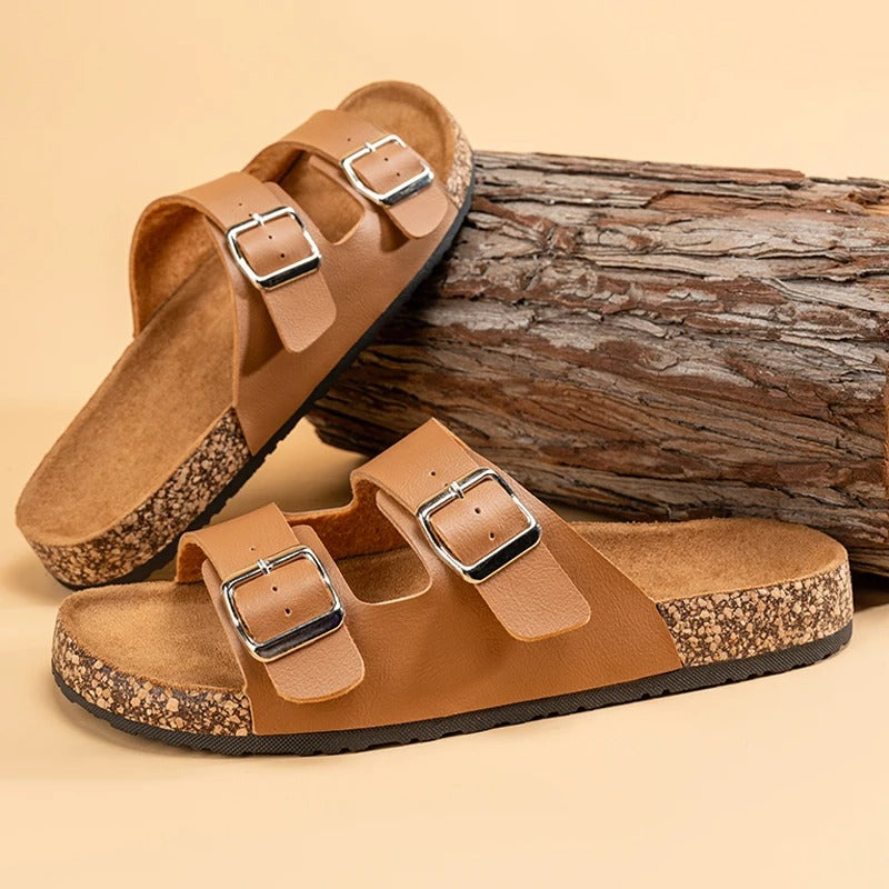 A person's feet wearing black Unisex Comfort Double Buckle Slide Sandals, casual and stylish.