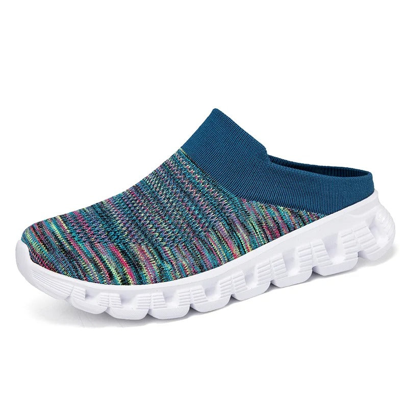 Model wearing black unisex cushioned knit slip-on shoes for casual, easy wear