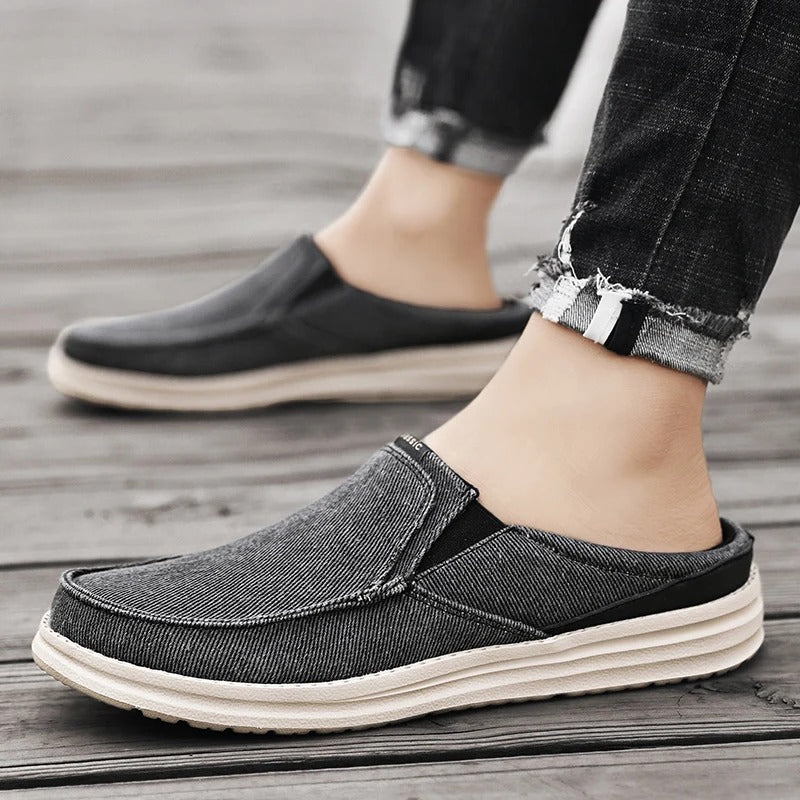Unisex denim mules on a wooden floor, highlighting their casual style