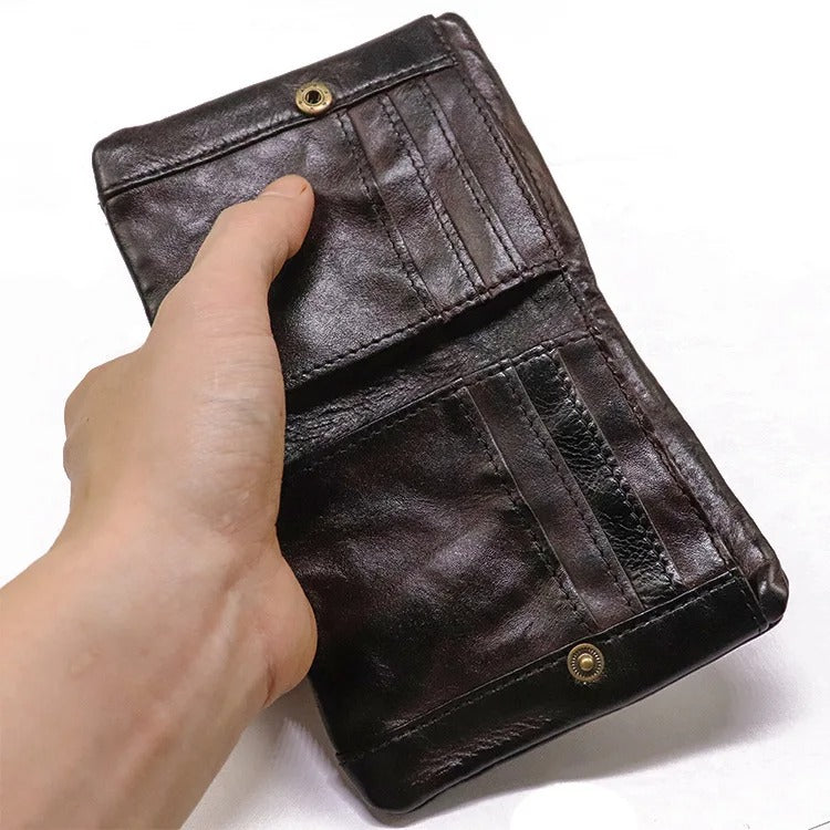 Front view of a rugged distressed leather wallet, secured with a metal snap