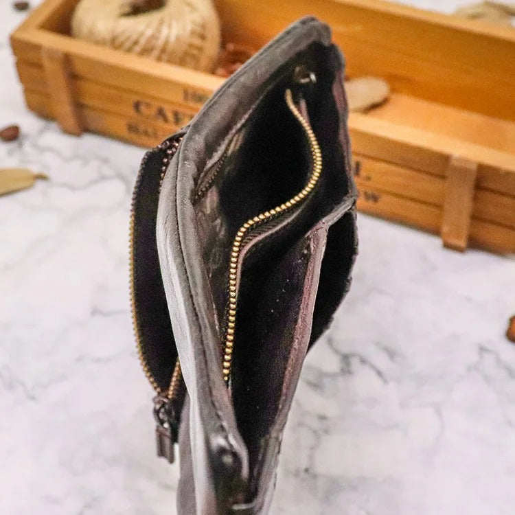 Open view of a distressed leather wallet, showing card slots and snap closure