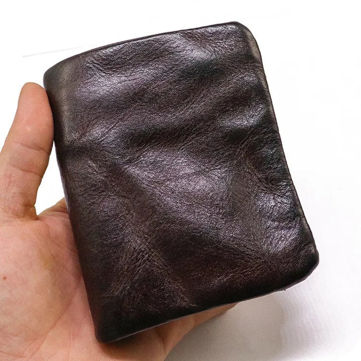 Texture detail of the aged, distressed leather on a snap-closure wallet