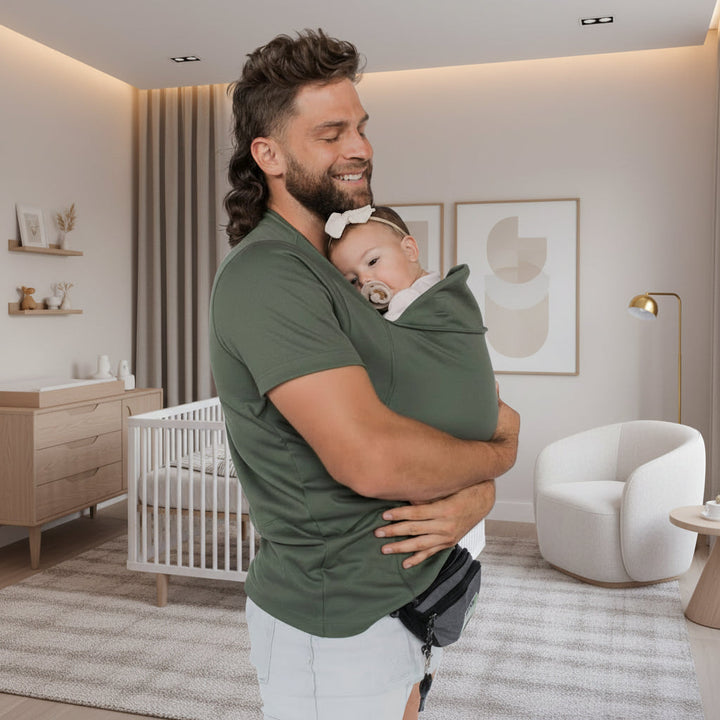 Happy parent with an infant in a hands-free, ergonomic baby carrier t-shirt, perfect for active parenting.