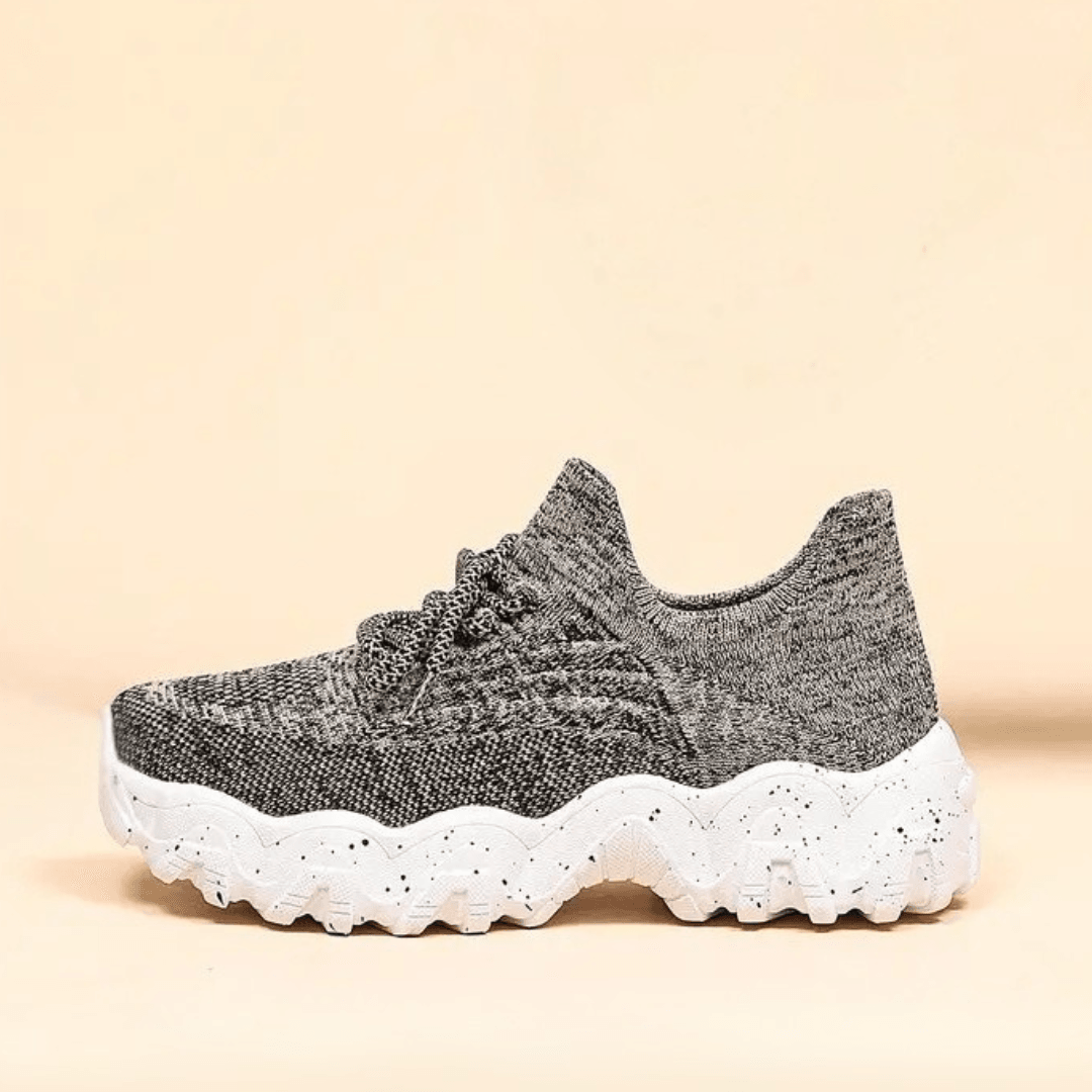 Reflection of Unisex Everyday Comfort Low-Top Sneakers, showing their clean profile and athletic casual look
