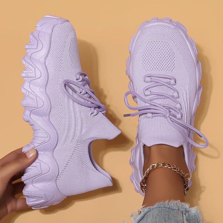 Unisex Everyday Comfort Low-Top Sneakers worn with jeans, showcasing their everyday casual appeal and versatility