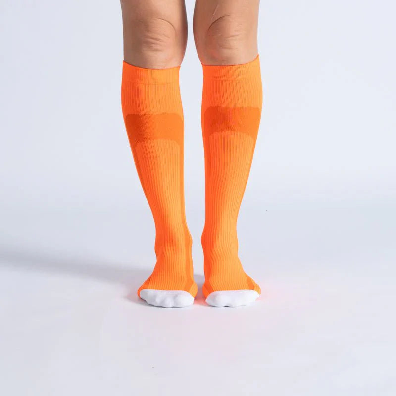 Unisex gentle compression socks in bright orange-vanilla blend for comfortable, everyday support