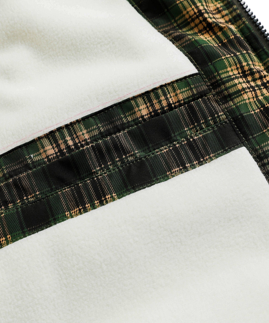 Unisex insulated vest in green, folded neatly on a camping background