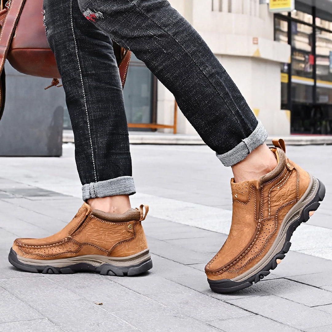 A person wearing black leather unisex high-top orthopedic shoes, experiencing comfort and stability