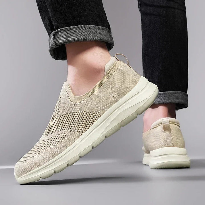 Breathable grey knit sneakers, a slip-on style for unisex casual and comfortable walking.