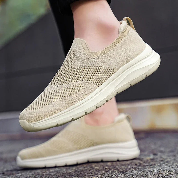 Unisex casual slip-on sneakers in black, made with a soft knit fabric for maximum comfort.
