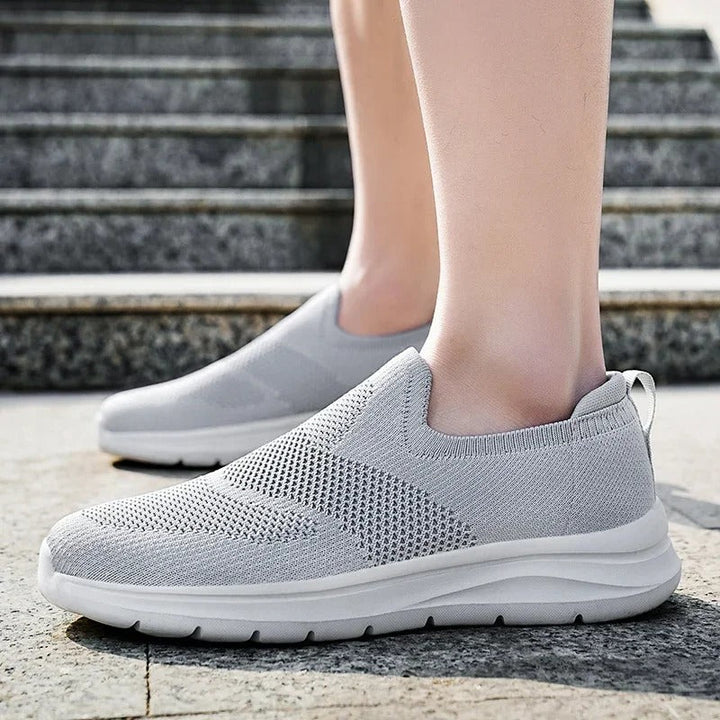 Unisex knit walking shoes in a convenient slip-on design, providing breathability and comfort.