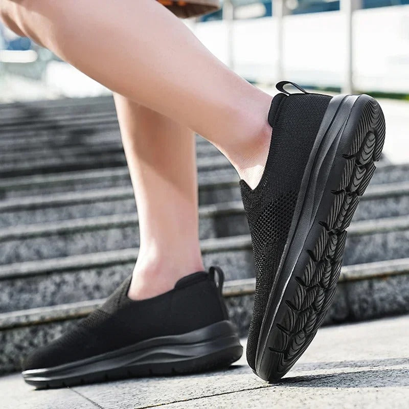 Pair of unisex knit casual slip-on sneakers, perfect for men and women seeking comfort footwear.