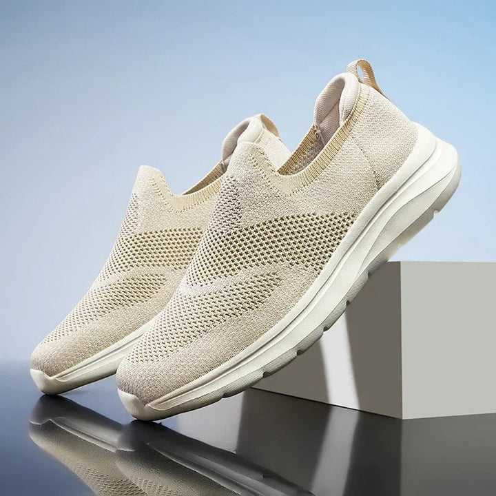 Lightweight unisex knit walking shoes in a neutral color, designed for easy wear and breathability.
