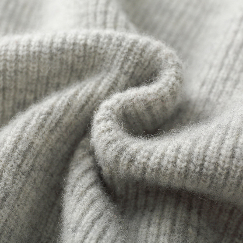 Detail of the full-zip closure on a Unisex Merino Wool Hoodie, highlighting quality knitwear.