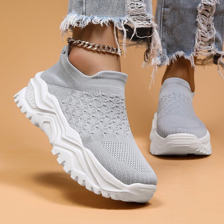 Overhead shot of orthopedic gray and white slip-on shoes, highlighting their minimalist and comfortable design