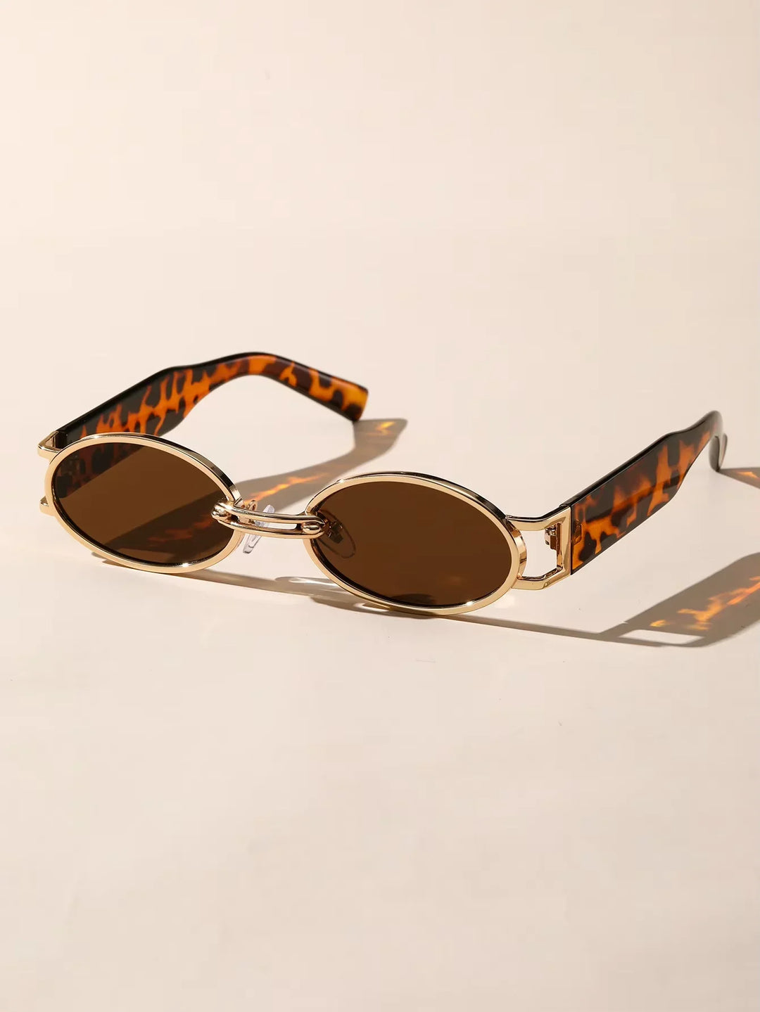 Stylish Unisex Oval Luxe UV400 Sunglasses, front view, reflecting a sunny sky