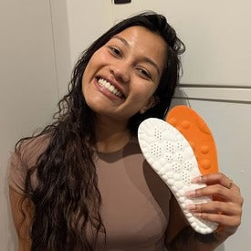Close-up of unisex foot pads designed for massage and pain relief, highlighting textured surface & comfort