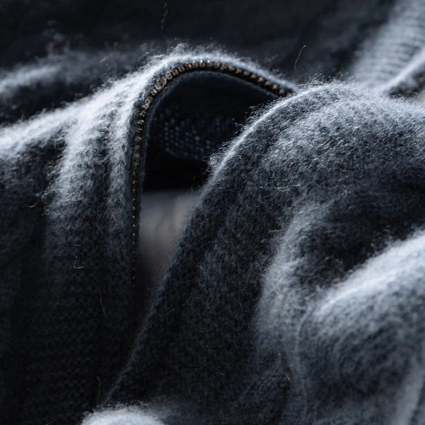 Detail of the high-quality zipper on a luxurious unisex cashmere cable knit cardigan.