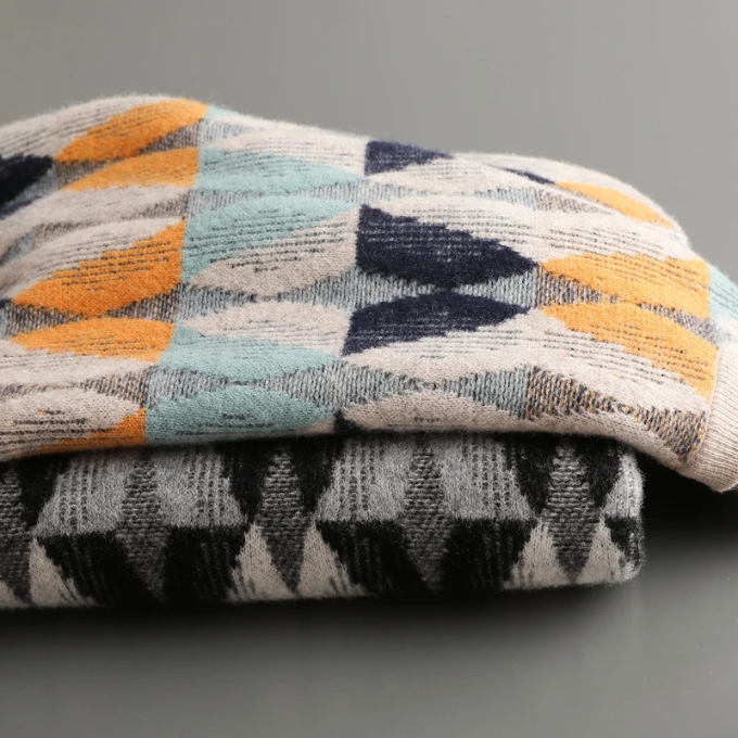 Folded premium cashmere geometric sweater, emphasizing its softness and elegant winter fashion appeal