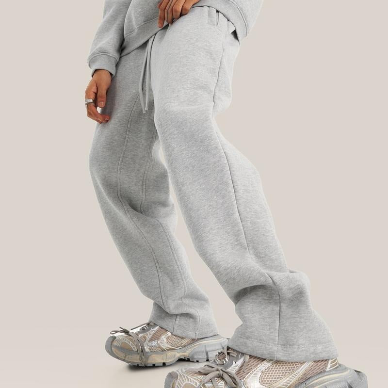Model wearing casual unisex relaxed fit fleece sweatpants, showcasing the comfortable wide leg design