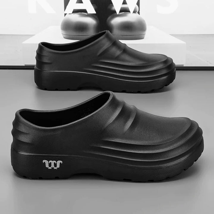Side view of a professional work clog highlighting its ergonomic design and easy-to-clean, waterproof material.