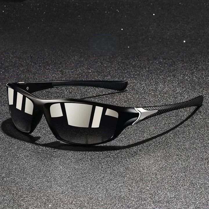 Close-up of durable orange sports sunglasses, showing UV400 protection & athletic, glare-reducing design.