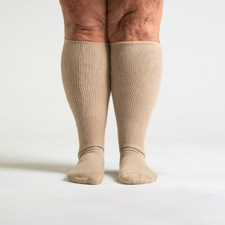 Pair of tan unisex compression socks, designed for improved circulation.