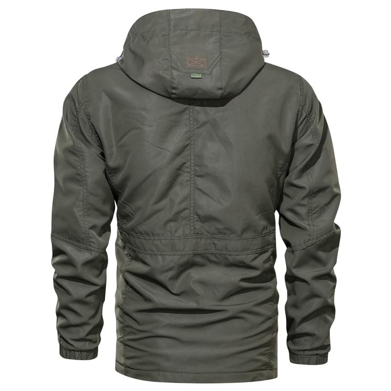 Full-length shot of a person hiking in a green Unisex Ultralight Outdoor Parka, suitable for all genders