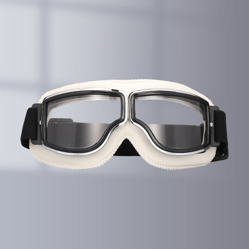 Rider wearing vintage motorcycle goggles, ensuring clear vision & eye safety. Essential retro riding gear.
