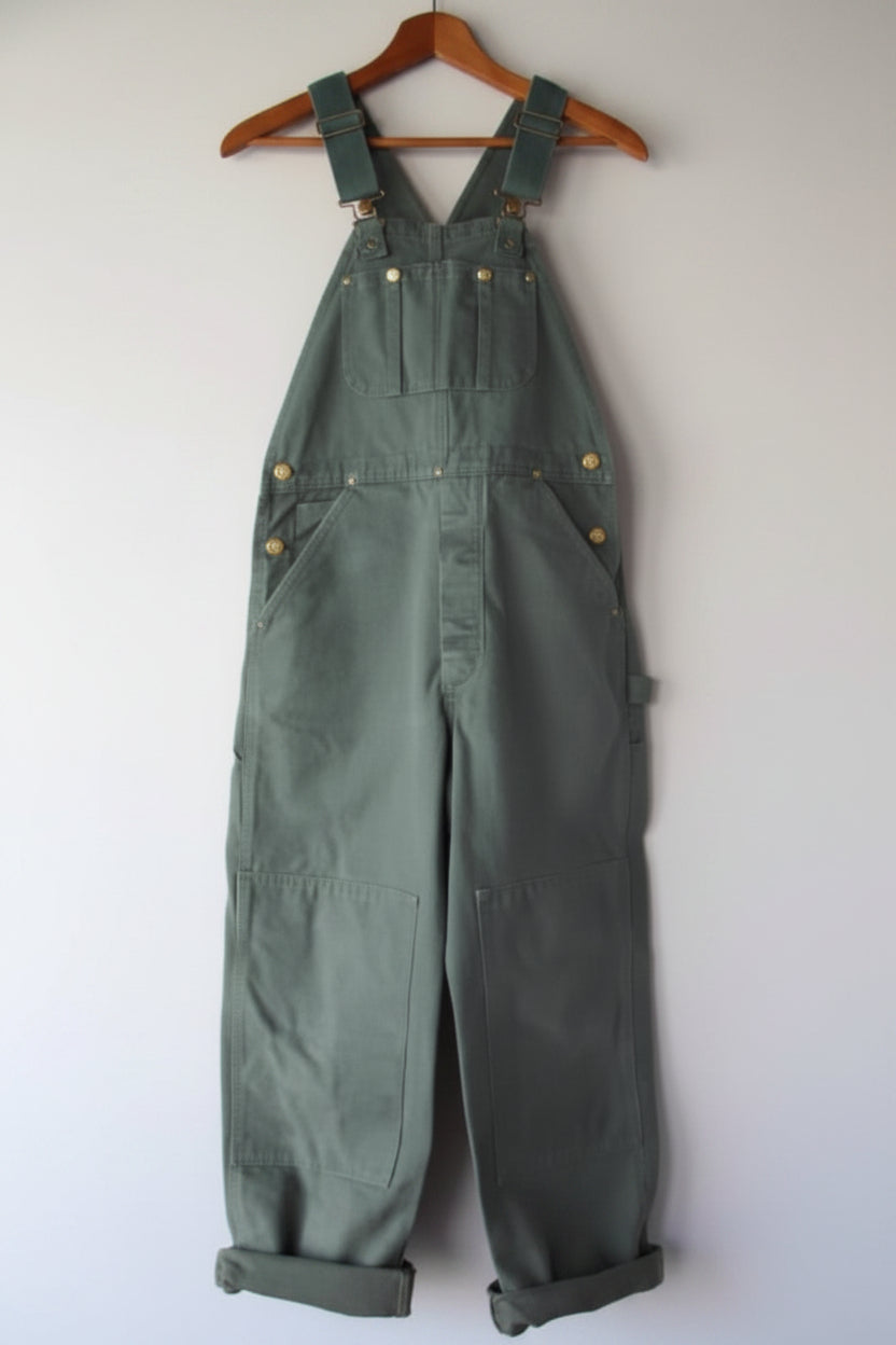 Green unisex vintage-style bib overalls with adjustable straps & functional pockets; perfect for casual comfort.