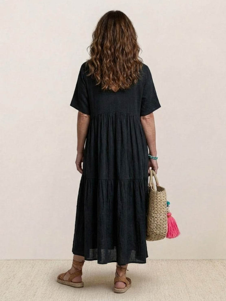 Graceful women's V-neck tiered maxi dress, boho style, perfect for summer strolls.