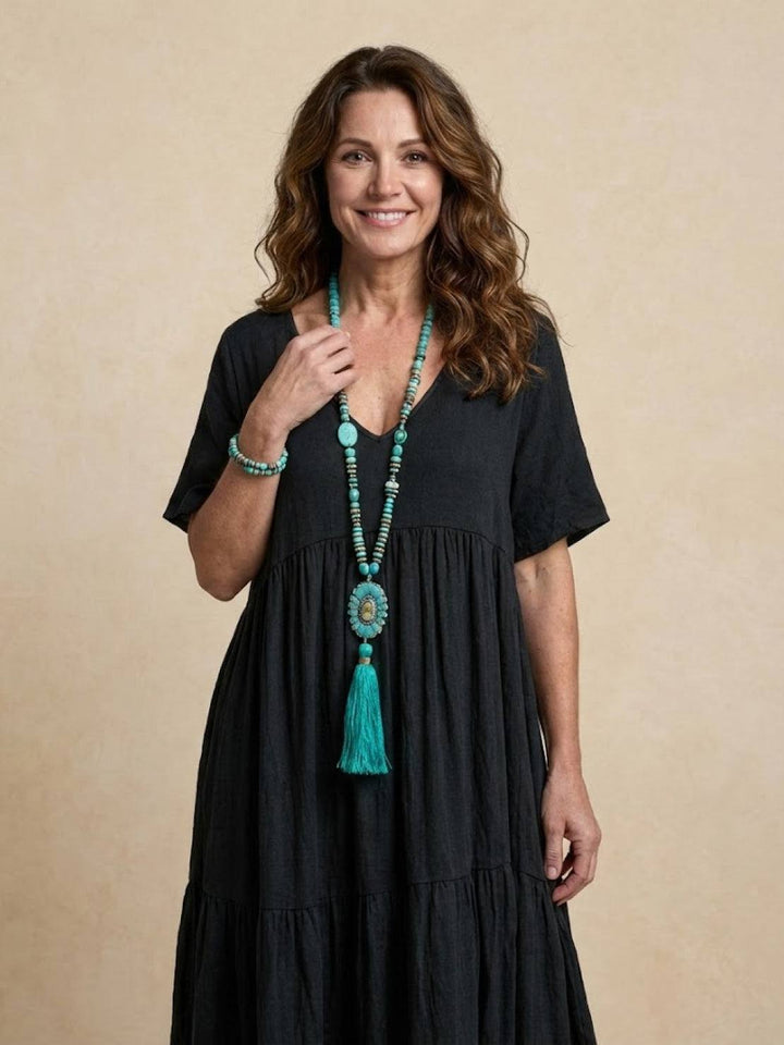 Women's resort V-neck tiered maxi dress, elegant flowy bohemian vacation attire.