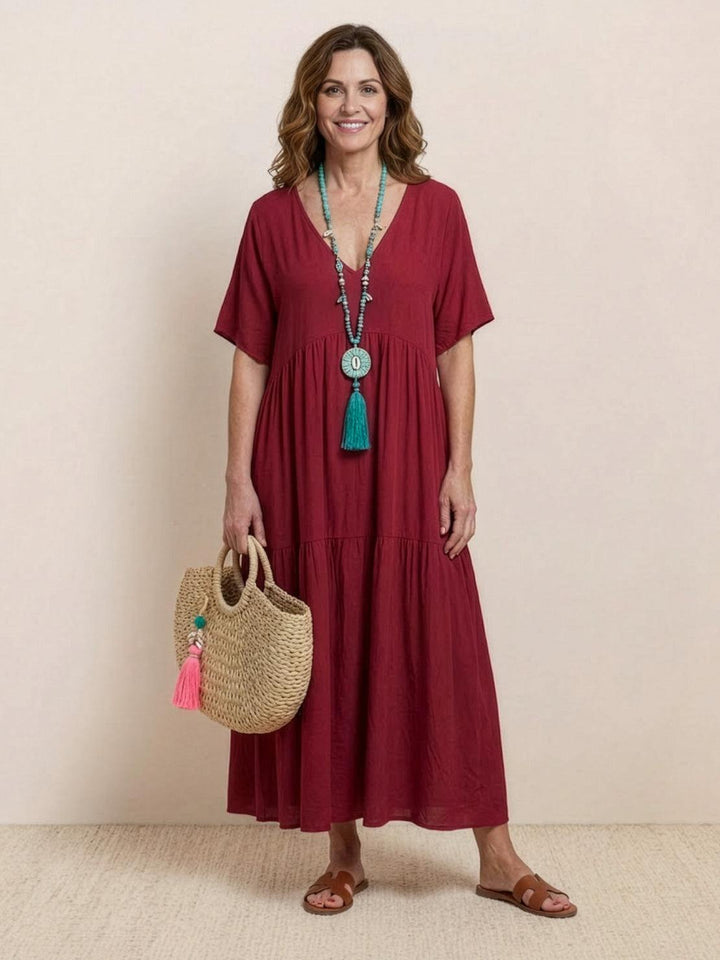 Bohemian women's long V-neck tiered dress, flowy silhouette, perfect for summer events.