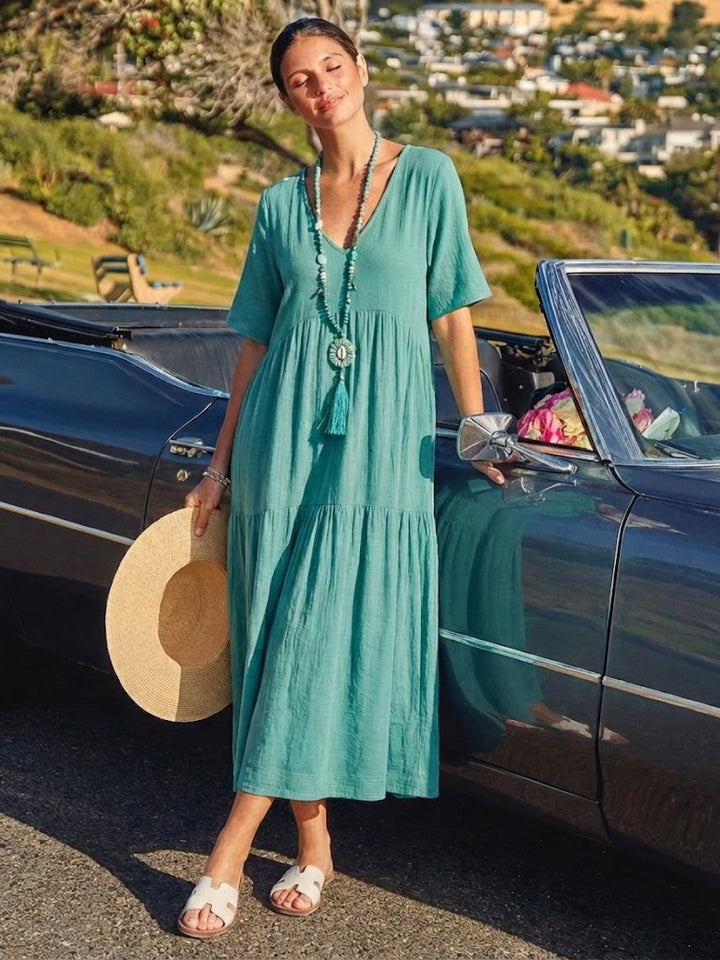 Casual women's boho V-neck tiered dress, long & comfortable, perfect for sunny days.