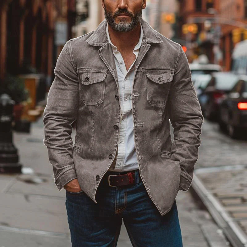 Close-up of durable men's utility jacket pockets, showcasing rugged, distressed look.