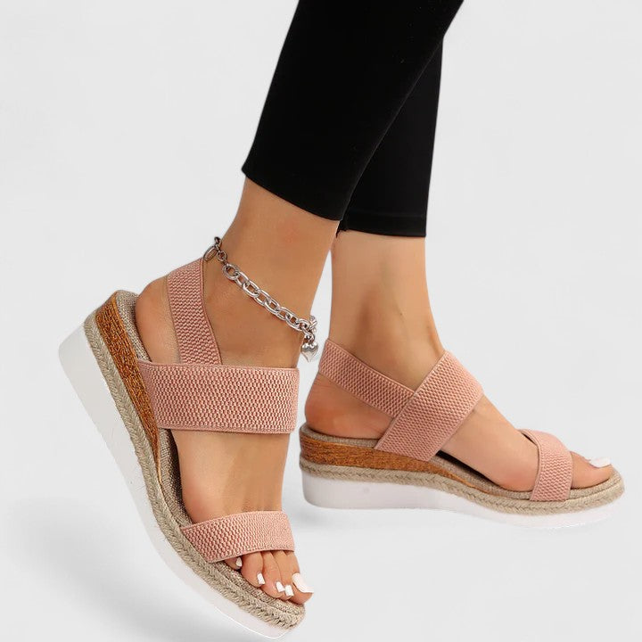 Woman enjoying a walk in comfortable orthopedic wedge sandals, showcasing stability & support.
